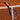 Two tennis racquets leaning against a net on a clay tennis court
