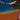 Tennis player gripping racket on clay court demonstrating how to prevent tennis elbow with proper technique