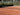 Empty tennis clay court with net ready for play, ideal for expert tennis instruction and training