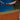 Tennis player gripping racket on clay court demonstrating forearm use to prevent tennis elbow
