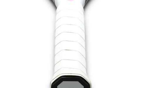 Close-up of a tennis racket handle wrapped with a white grip, emphasizing the importance of measuring tennis grip size for optimal play.