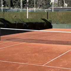 Empty tennis clay court with net ready for play, ideal for expert tennis instruction and training