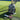 Tennis rackets and Mantis backpack on grass court with focus on tennis racket shock absorber