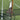 Two tennis racquets leaning against a net on a grass tennis court representing tennis racquet stringing tension concepts