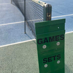 Tennis court net with scoreboard showing games and sets counters in green panel
