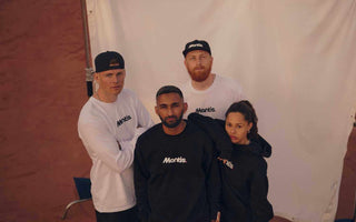 group of young adults in mantis sportswear posing on tennis court for beginners photoshoot
