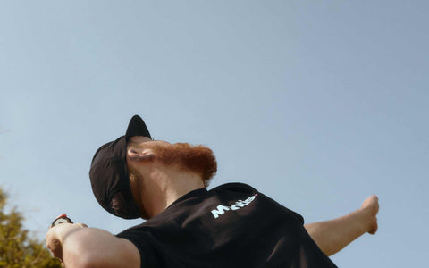 Tennis player preparing to serve with racket and tennis ball in clear sky background, illustrating tennis strings tension concept