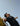 Tennis player practicing tennis serve technique preparing to hit ball in outdoor court with clear sky background