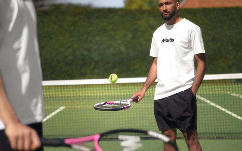 Man playing tennis with Mantis tennis racket on outdoor court, best tennis rackets for spin demonstration