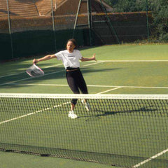 woman playing tennis with best tennis racket on outdoor court