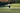 female tennis player swinging racket on outdoor tennis court during daytime