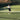 female tennis player swinging racket on outdoor tennis court during daytime
