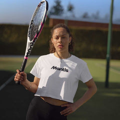 Young woman holding a Mantis tennis racket on an outdoor tennis court