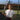 Woman holding tennis racket on outdoor court wearing Mantis shirt for buying a tennis racket guide