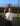 Woman holding tennis racket on outdoor court wearing Mantis shirt for buying a tennis racket guide