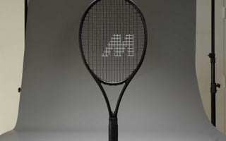 Black tennis racket with neatly strung strings in professional studio setup for tennis racket stringing guide