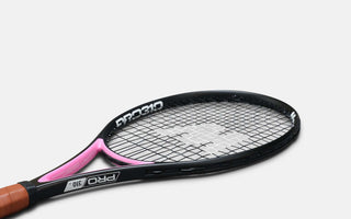 Mantis tennis racket with black frame, pink throat, and brown grip designed for precision and performance
