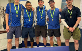 Amateur team tennis players posing with medals at LTA Tennis event in Britain